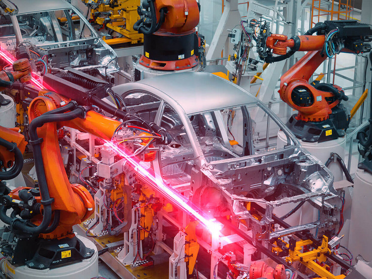 Car being manufactured by automated robots with red EPLAN flash